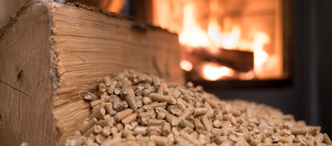 Wood,Stove,Heating,With,In,Foreground,Wood,Pellets,-,Economical