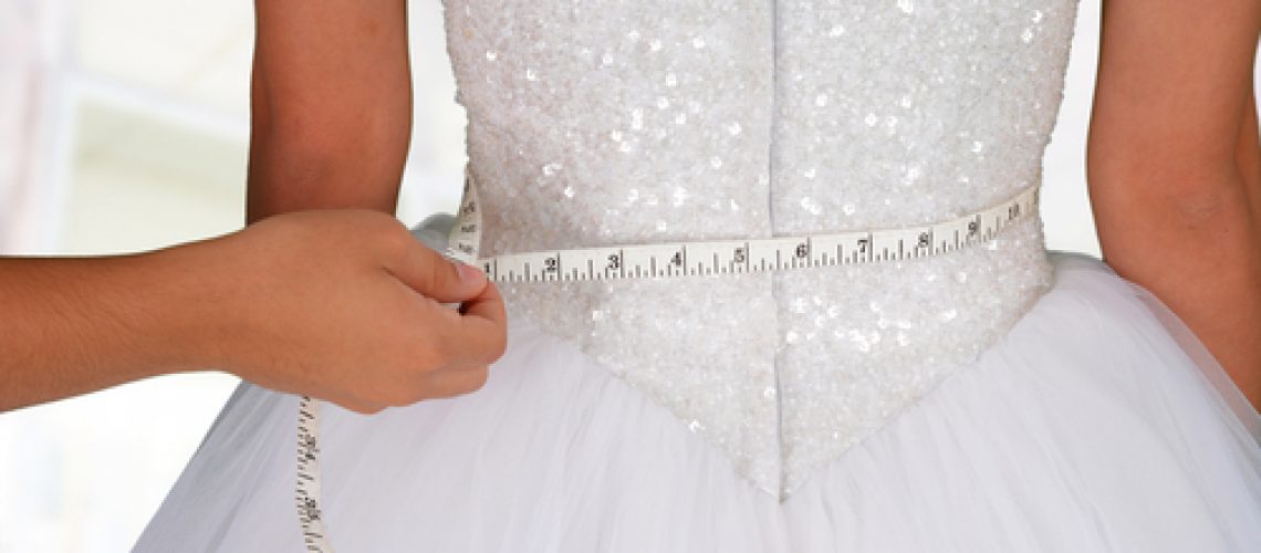 Woman,In,A,Wedding,Dress,Getting,Measured